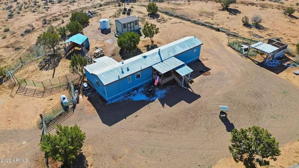 an aerial view of a house with a yard and lake view