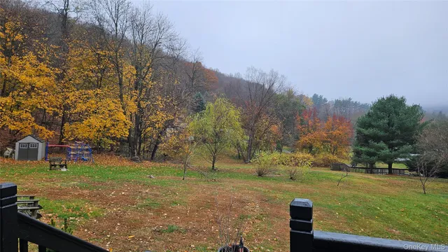 a view of a yard with large trees