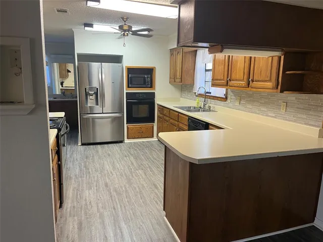 a kitchen with a refrigerator and a sink