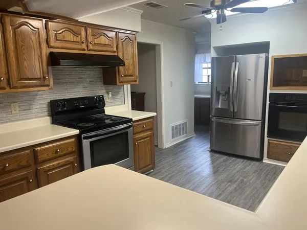 a kitchen with a refrigerator and a sink