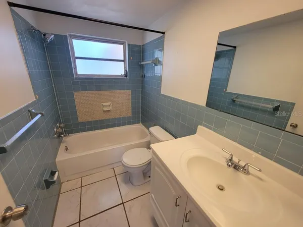 a bathroom with a sink mirror vanity and toilet