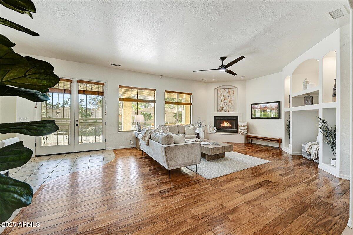4409 East Janice Way Phoenix, AZ 85032 - Photo 11 of 41 a living room with fireplace furniture and a wooden floor