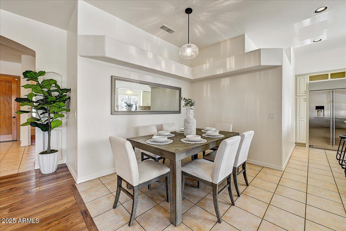 4409 East Janice Way Phoenix, AZ 85032 - Photo 13 of 41 a view of a dining room with furniture window and wooden floor