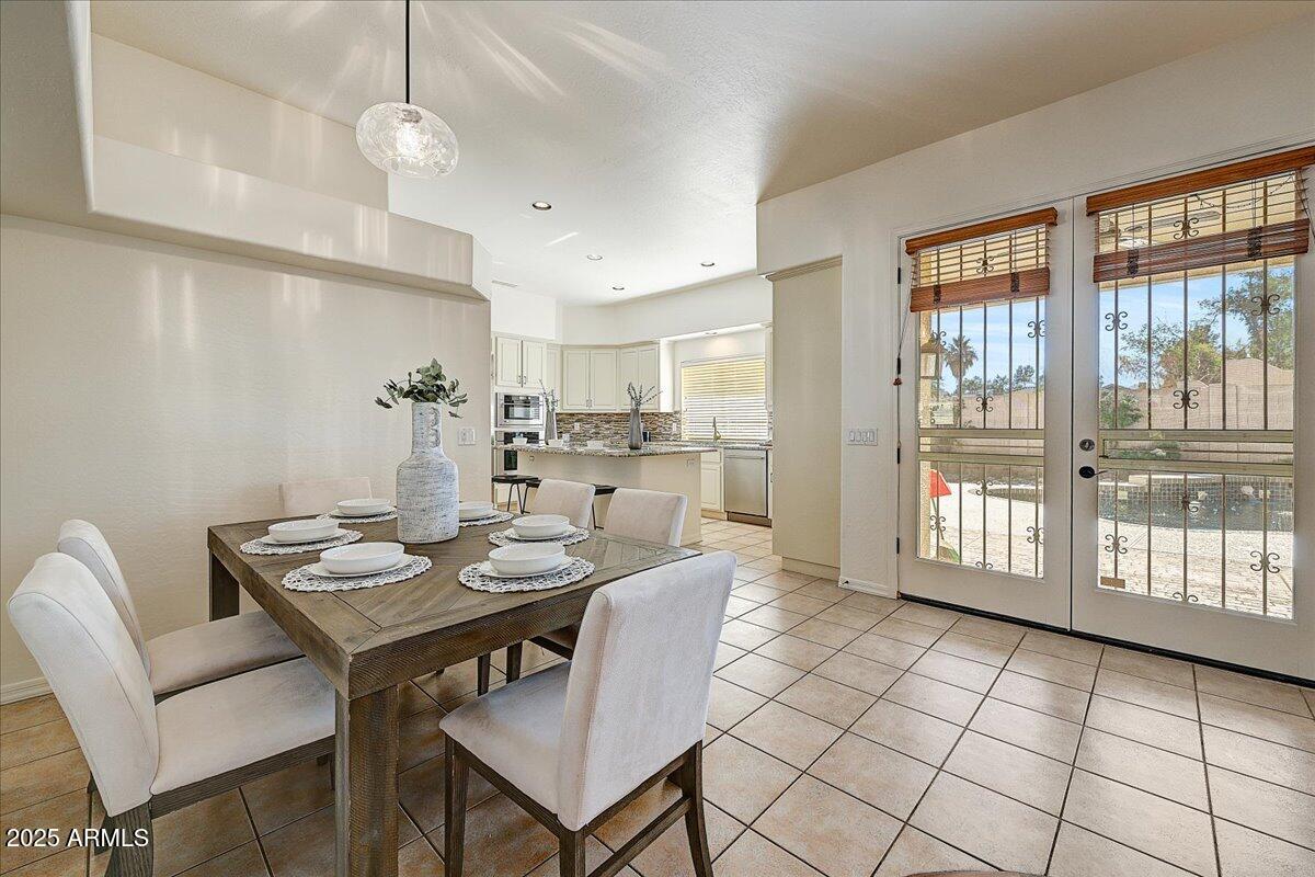 4409 East Janice Way Phoenix, AZ 85032 - Photo 14 of 41 a view of a dining room with furniture wooden floor and chandelier