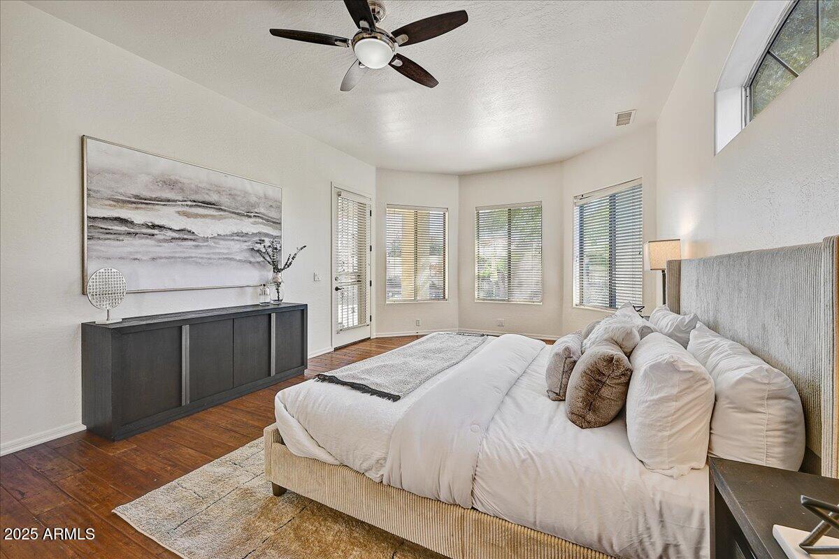 4409 East Janice Way Phoenix, AZ 85032 - Photo 21 of 41 a bedroom with a bed and a chandelier