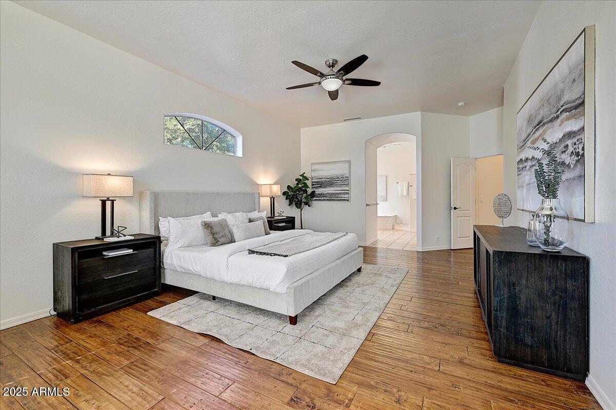 4409 East Janice Way Phoenix, AZ 85032 - Photo 22 of 41 a large bedroom with a bed and wooden floor