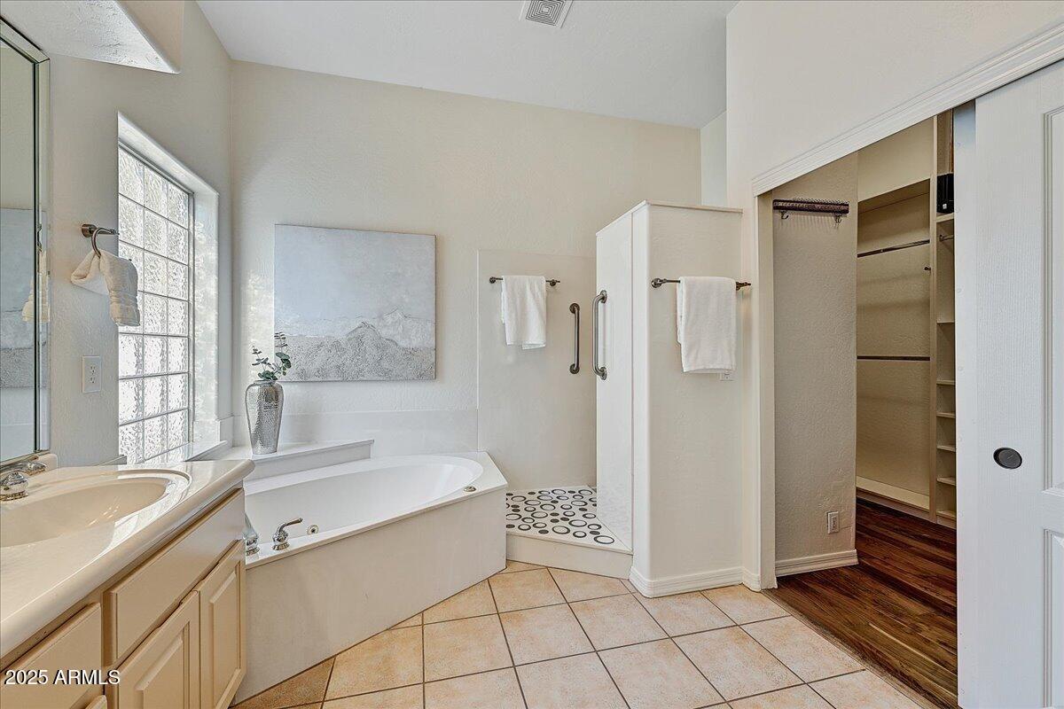4409 East Janice Way Phoenix, AZ 85032 - Photo 25 of 41 a spacious bathroom with a tub shower and a sink