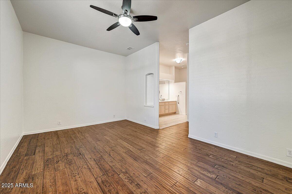 4409 East Janice Way Phoenix, AZ 85032 - Photo 27 of 41 a view of empty room with wooden floor and fan
