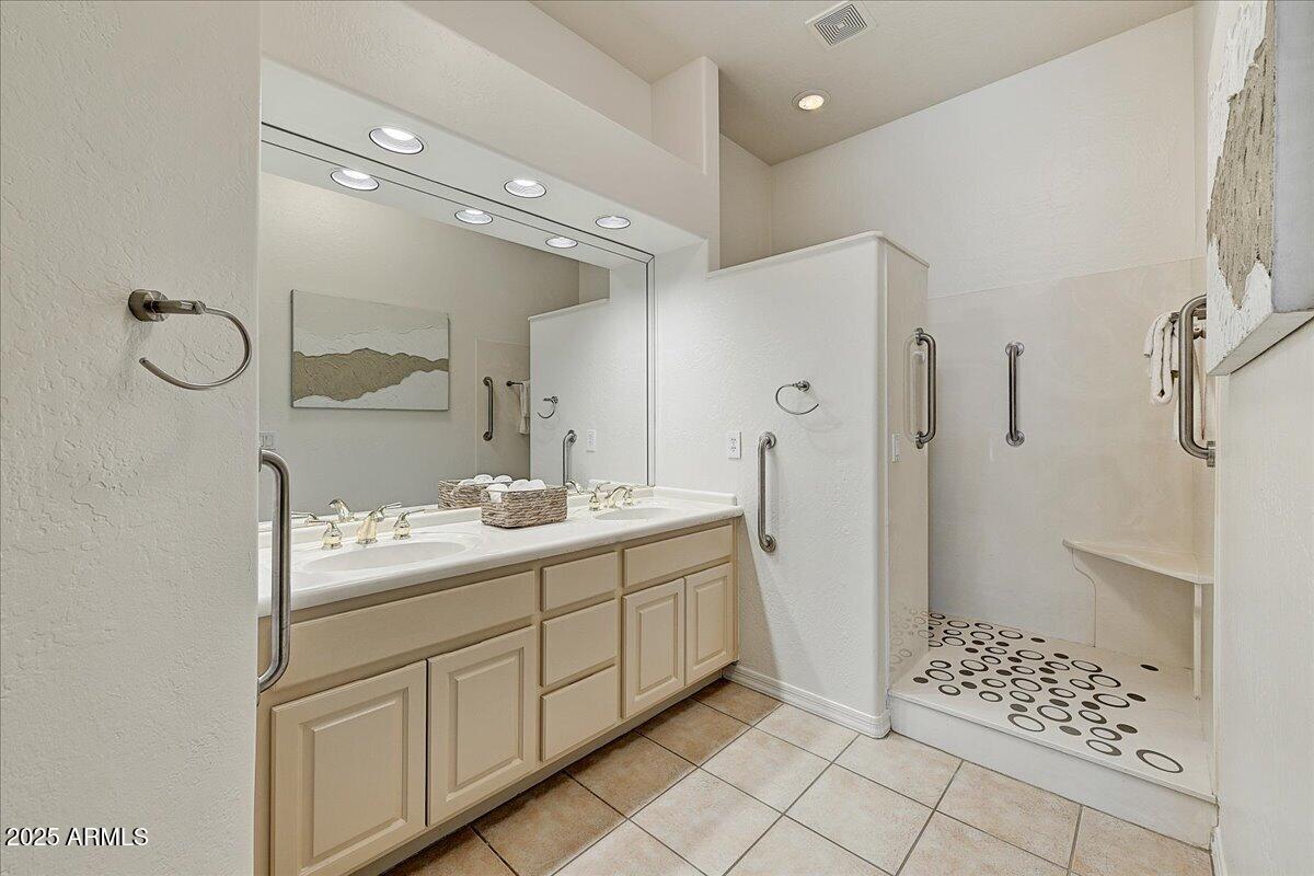 4409 East Janice Way Phoenix, AZ 85032 - Photo 29 of 41 a bathroom with a double sink shower and a mirror