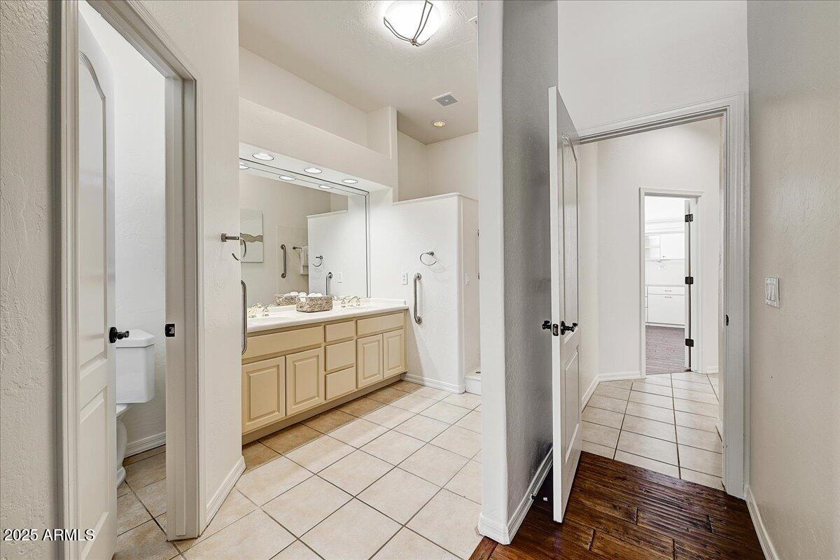 4409 East Janice Way Phoenix, AZ 85032 - Photo 30 of 41 a bathroom with a sink a mirror and a shower
