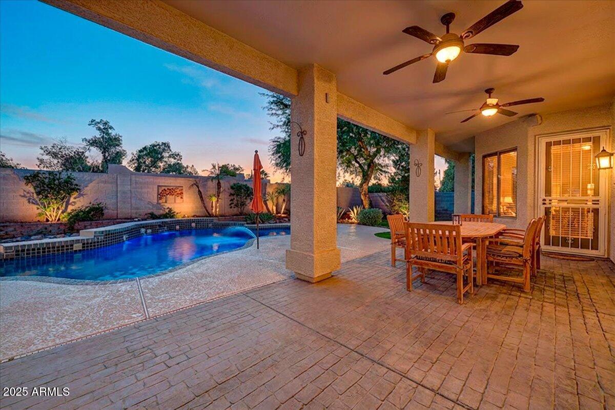 4409 East Janice Way Phoenix, AZ 85032 - Photo 3 of 41 a living room with furniture a chandelier and a floor to ceiling window