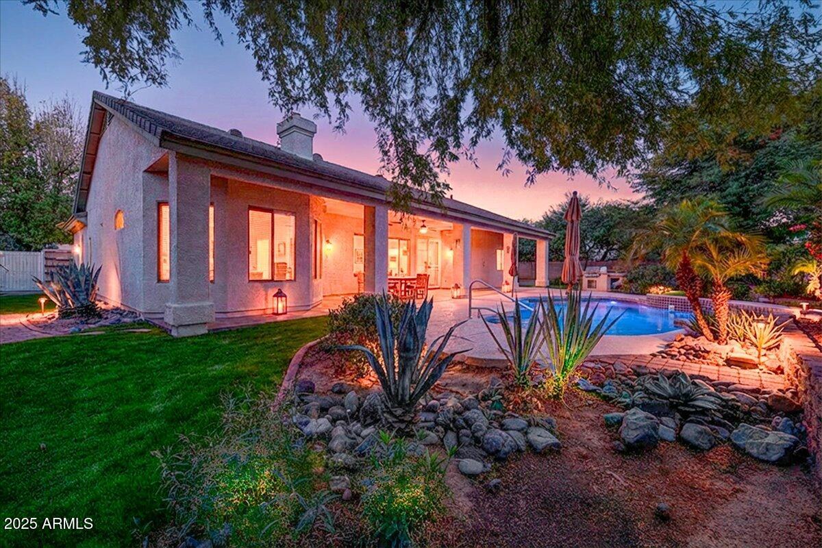 4409 East Janice Way Phoenix, AZ 85032 - Photo 4 of 41 a view of a backyard with potted plants and large tree