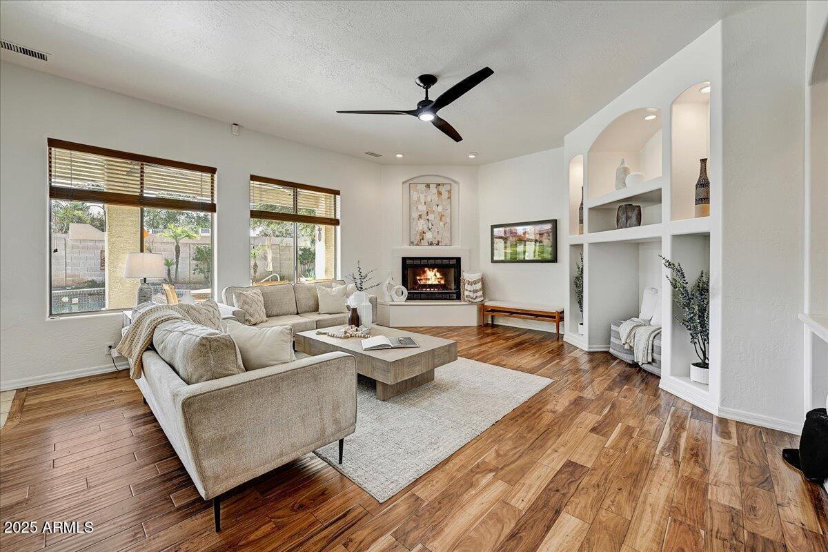4409 East Janice Way Phoenix, AZ 85032 - Photo 9 of 41 a living room with fireplace furniture and a wooden floor