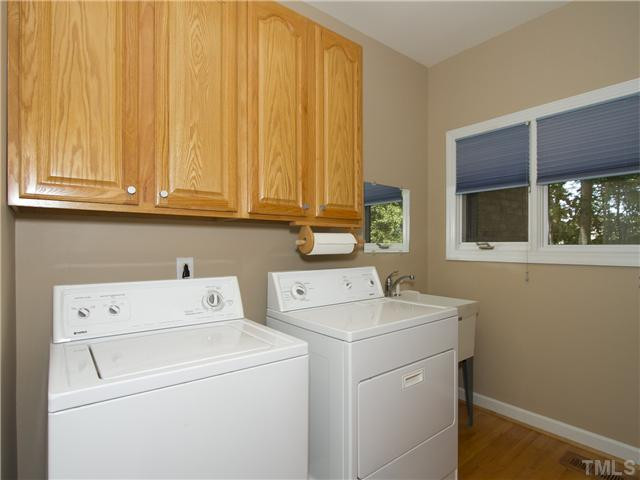 2108 Lovdal Drive Raleigh, NC 27613 - Photo 22 of 25 This incredible laundry room has a wet sink, windows, additional upper and lower cabinets and counterspace on other wall. Laundry Room