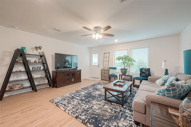 a living room with furniture and wooden floor