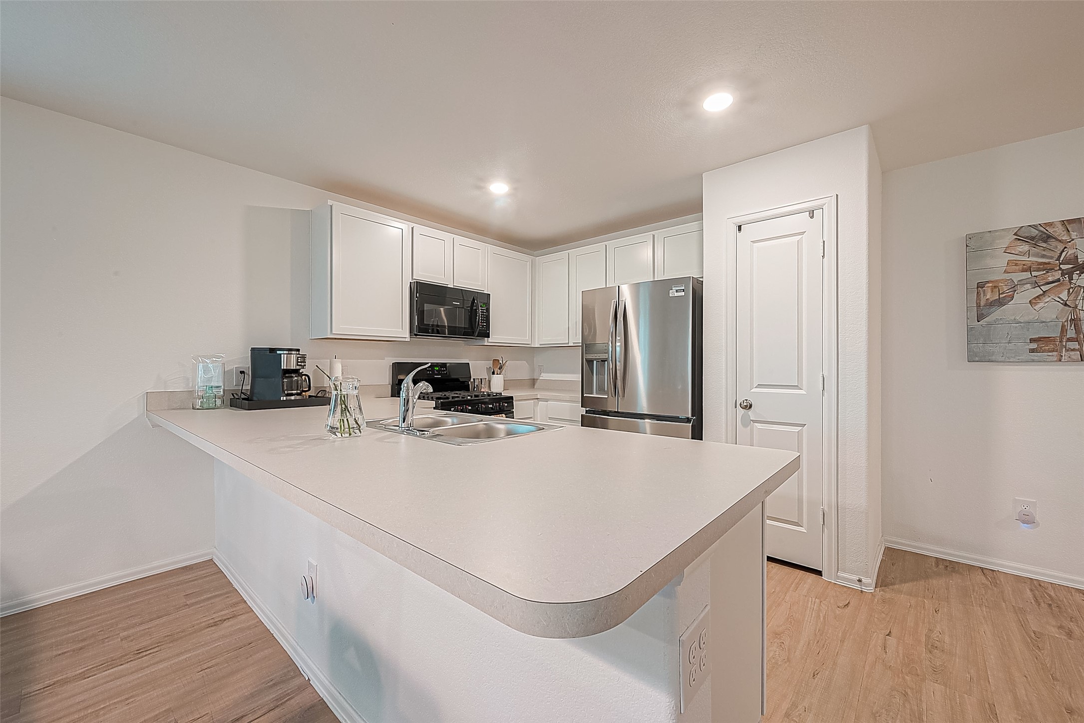 724 Cedar Gate Lane La Marque, TX 77568 - Photo 16 of 40 a kitchen with stainless steel appliances a refrigerator sink and microwave