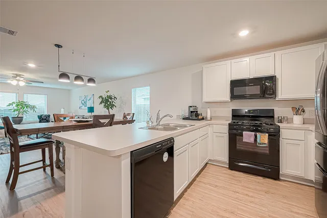 a kitchen with refrigerator and cabinets
