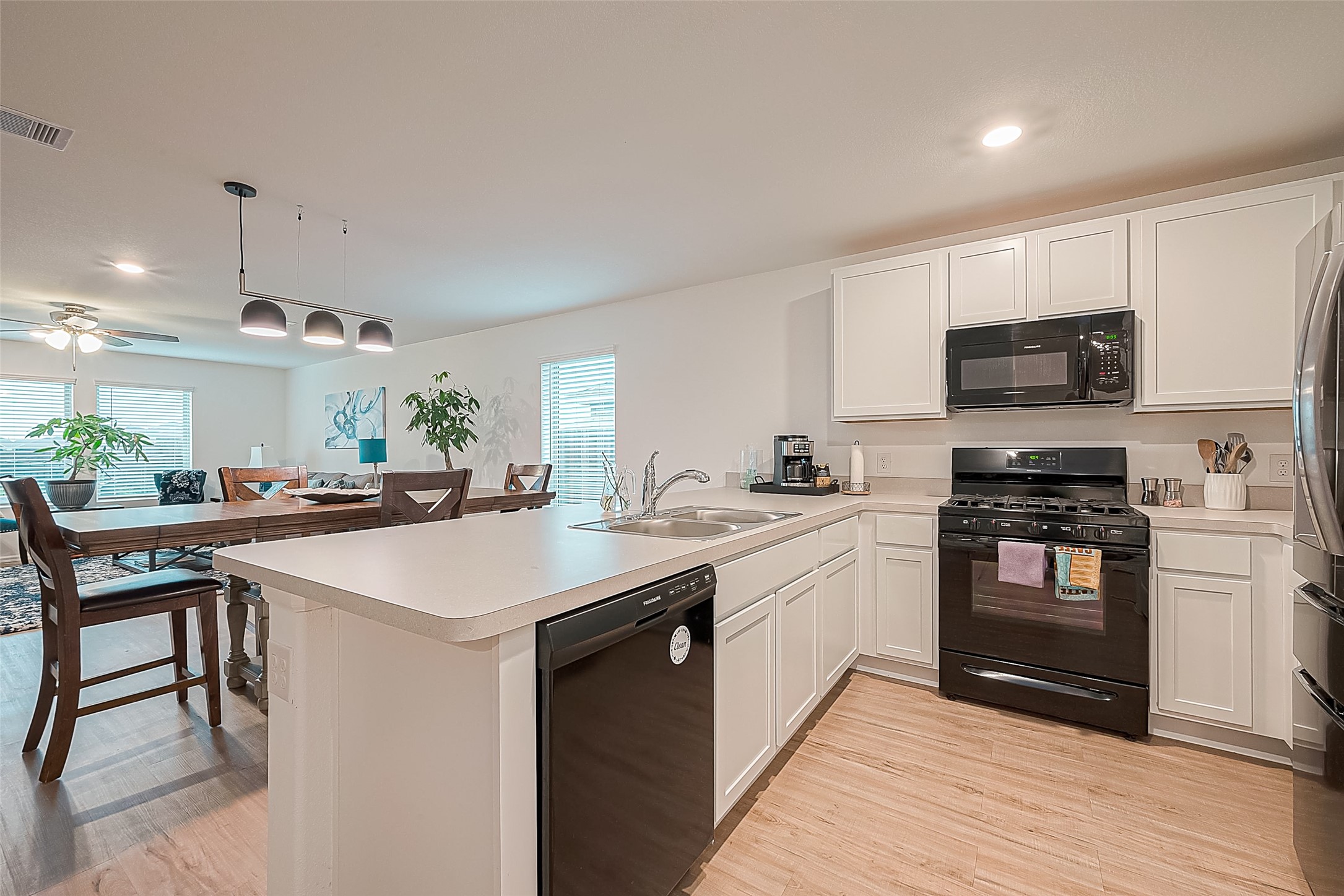 724 Cedar Gate Lane La Marque, TX 77568 - Photo 18 of 40 a kitchen with stainless steel appliances kitchen island granite countertop a sink a stove a microwave and a refrigerator