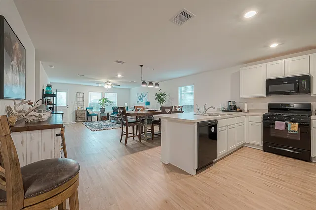 a kitchen with a sink a stove and cabinets