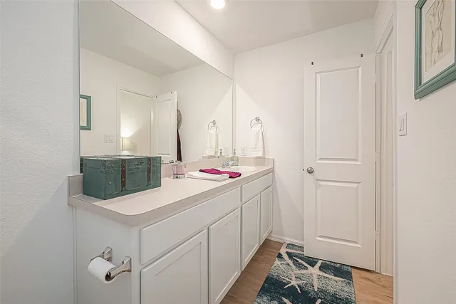 a bathroom with a sink toilet and a mirror