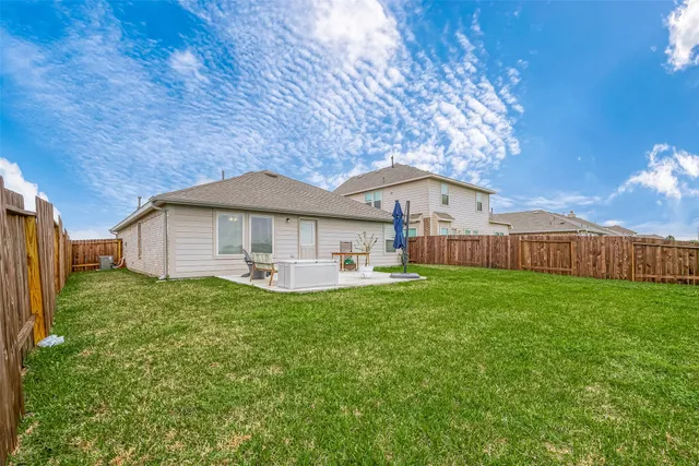 a view of a backyard with sitting area