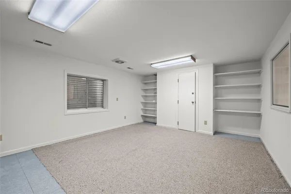 a view of an empty room with a closet