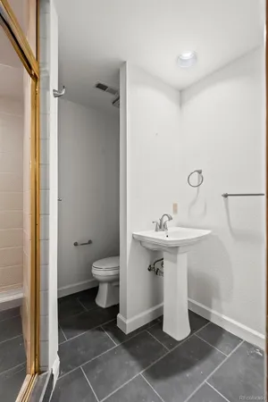 a bathroom with a sink toilet and shower