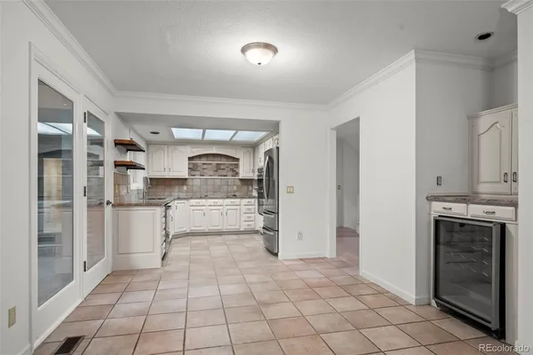 a kitchen with stainless steel appliances a refrigerator and cabinets