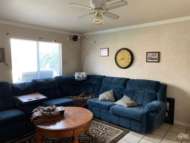 a living room with furniture a clock and a window
