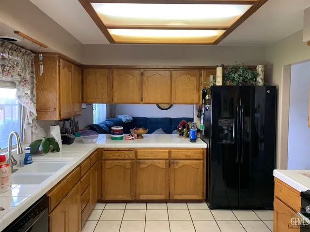 a kitchen with a refrigerator and a sink