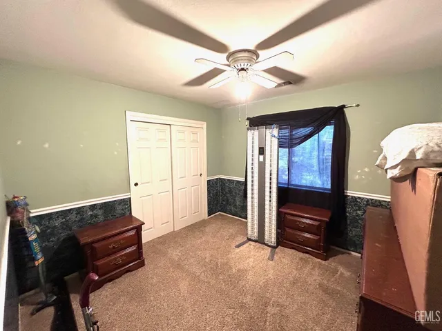 a living room with furniture and a ceiling fan