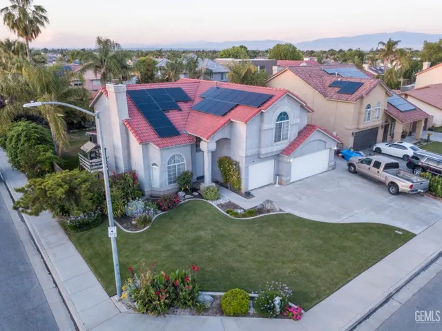 a aerial view of a house with swimming pool and a yard