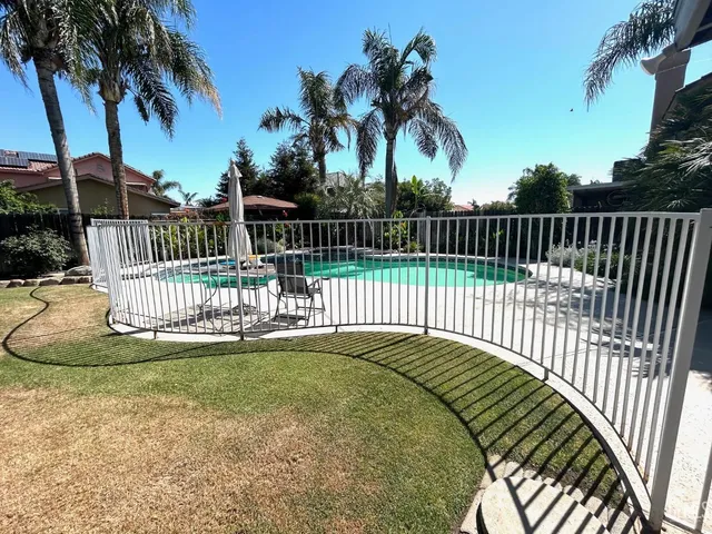 a view of a park with a iron fence