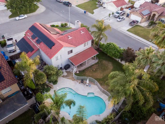 an aerial view of a house with a swimming pool