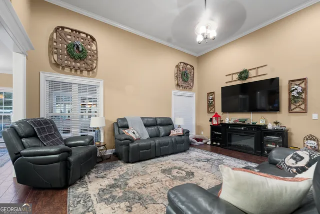 a bedroom with a bed and a lamp with the wooden floor