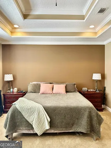 a bedroom with a bed and a lamp