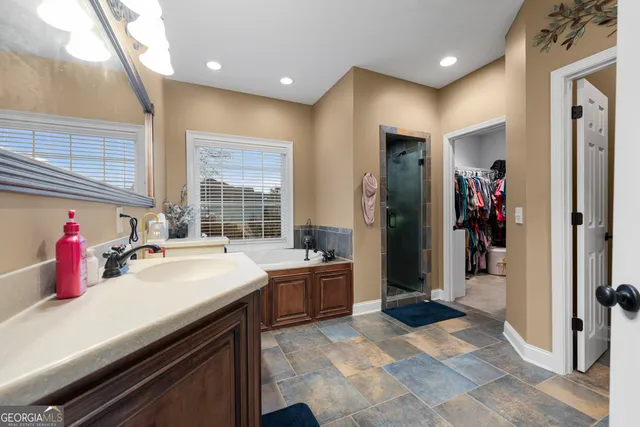 a bedroom with a bed a desk and a window