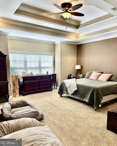 a bedroom with a bed and dresser with mirror