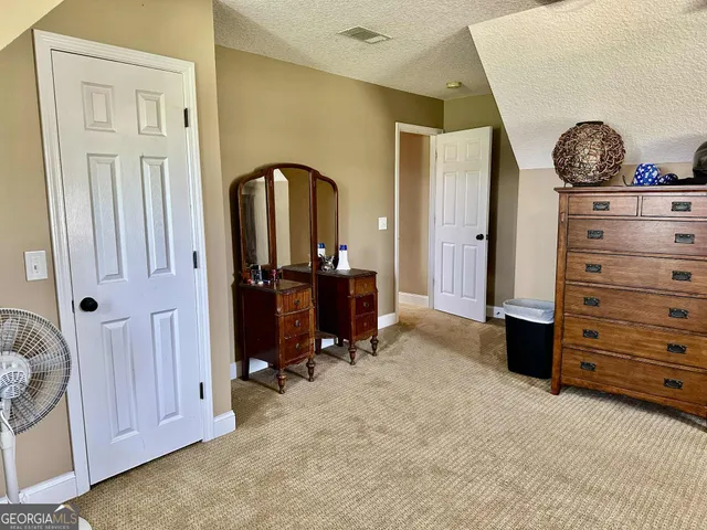 a bathroom with a toilet a sink and a mirror
