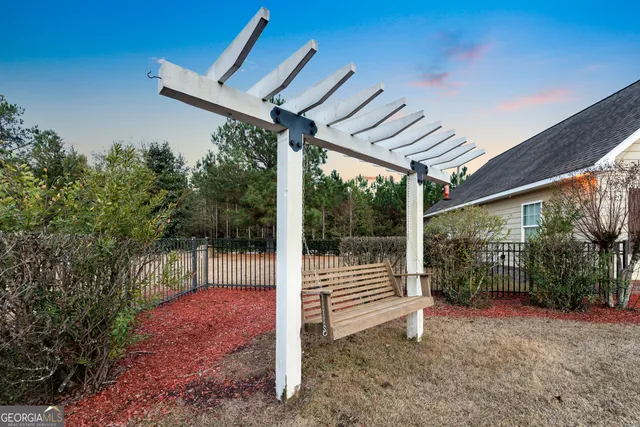 an aerial view of a house with garden space and street view