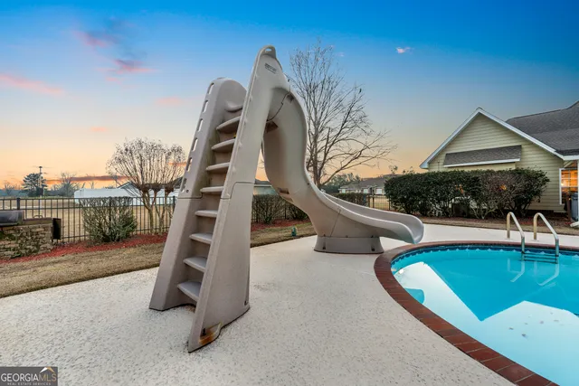 an aerial view of a house with a swimming pool