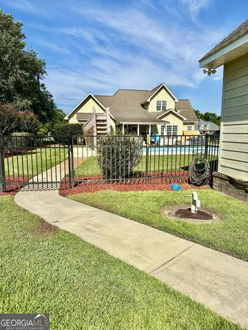 a front view of a house with a garden and plants