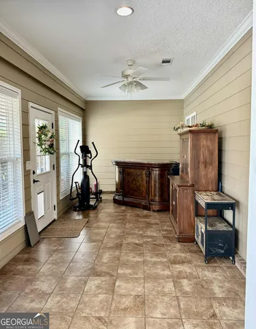 a view of a house with a barbeque and bench