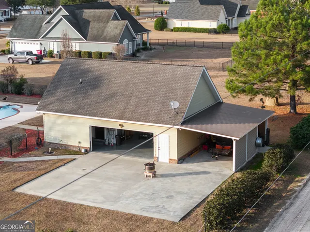 an aerial view of a house with a yard
