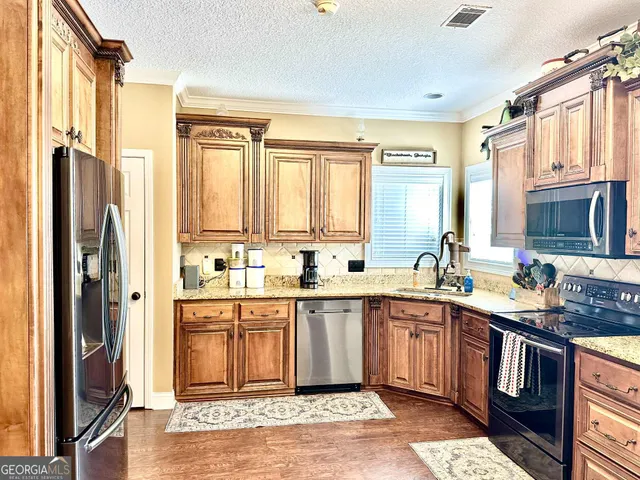 a kitchen with a sink stove and refrigerator