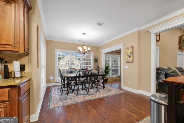 a view of a livingroom with wooden floor and furniture