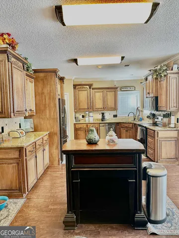 a kitchen with a sink appliances and cabinets