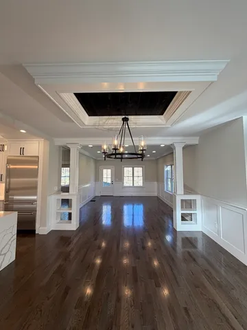 a view of empty room with wooden floor and fireplace