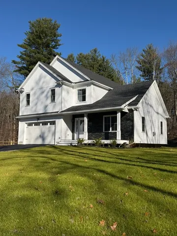 a view of a house with a big yard and large trees
