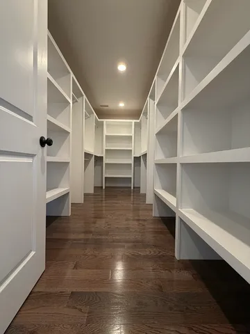 a view of walk in closet with empty racks